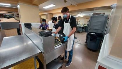 Eddie Malague, a soon-to-be-senior at Rutgers, helping prepare to-go meals at Elijah's Promise.