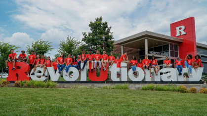 First-generation students sitting on 'Revolutionary' letters
