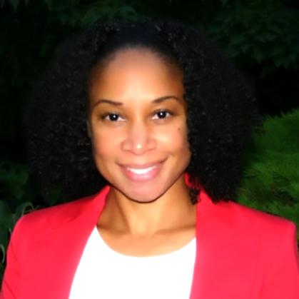 Kimberley is an african american woman with curly shoulder length hair. She is wearing a red blazer with a white blouse underneath.