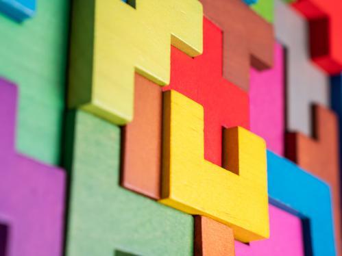 Blocks of different colors and sizes fitting together creating a multicolored mosaic.