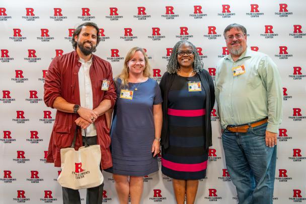 Four Rutgers staff and event panelists pose for a photo in front of a Tyler Clementi Center backdrop.